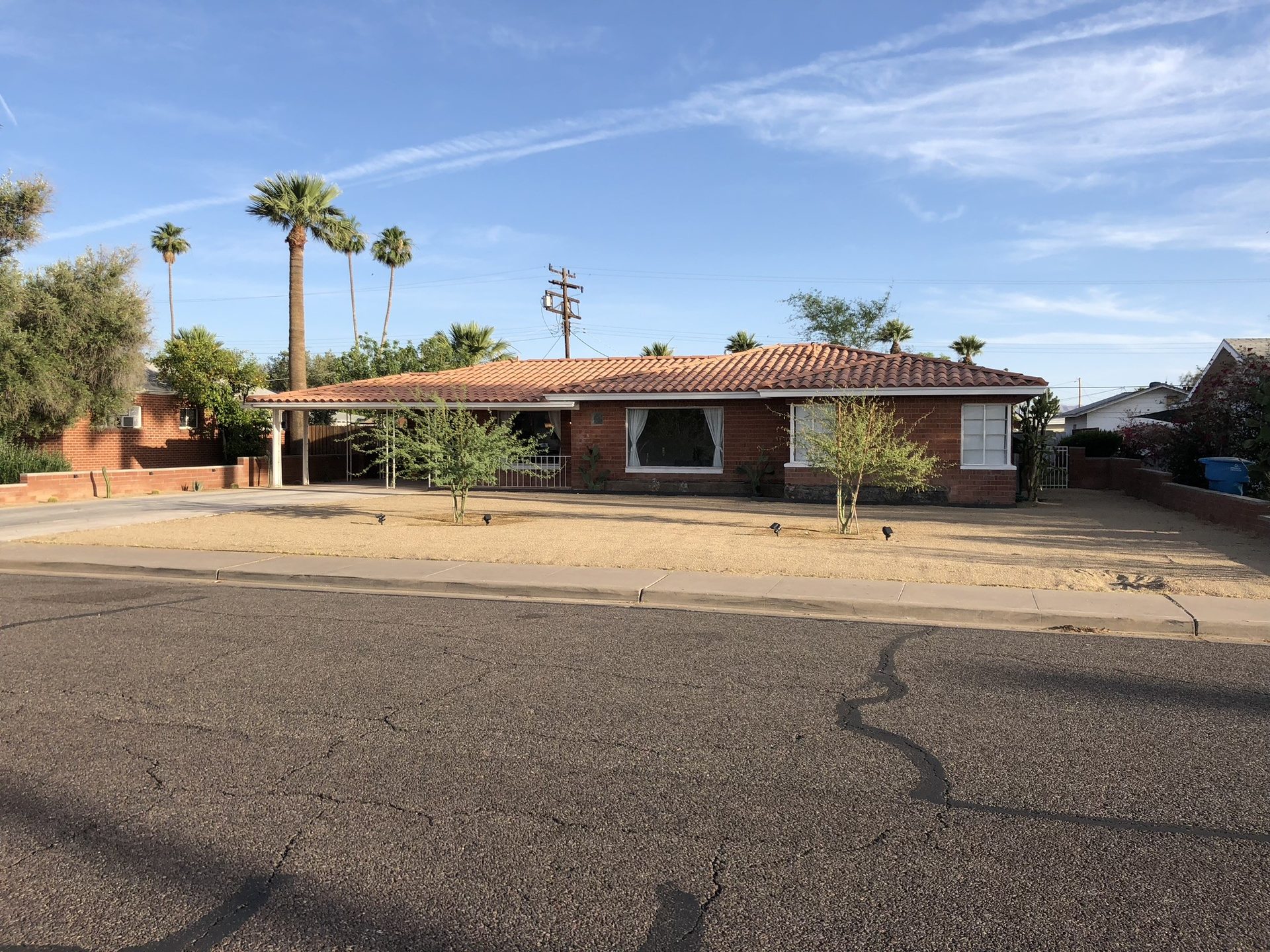 Low-water desert front yard with decomposed granite and cactus at a Phoenix brick ranch home