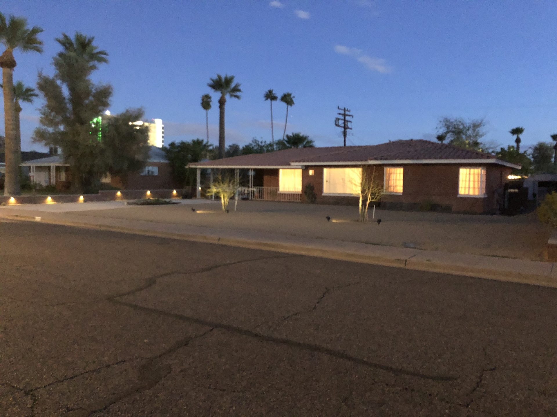 Phoenix desert front yard at twilight with landscape lighting on