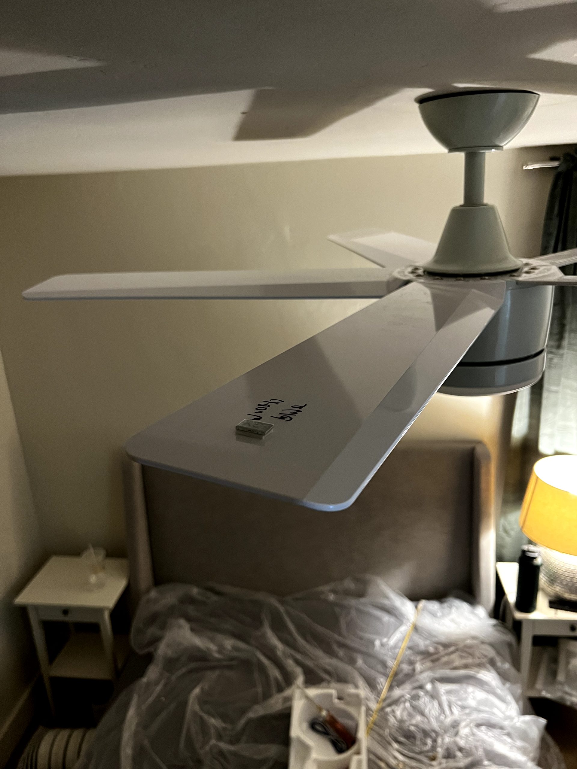 Stick-on balancing weight applied to a ceiling fan blade during installation