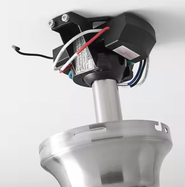 Ceiling fan receiver installed above the canopy on the mounting bracket, where it is hidden once the fan is up