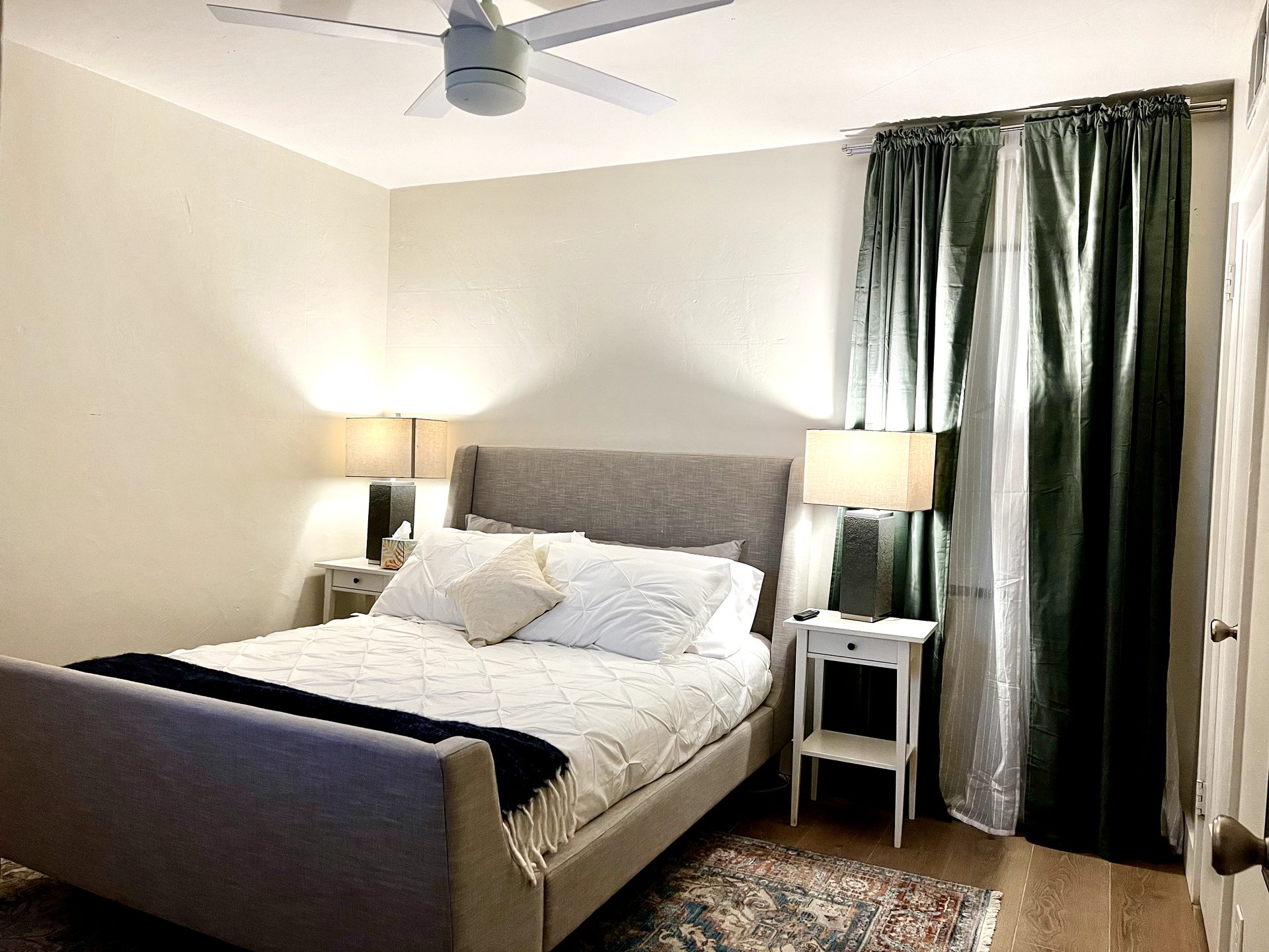 New modern five-blade ceiling fan with LED light installed in the finished bedroom