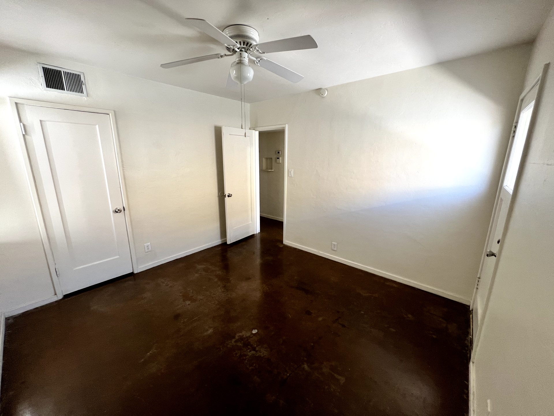Dated builder-grade ceiling fan in a Phoenix-area bedroom before replacement