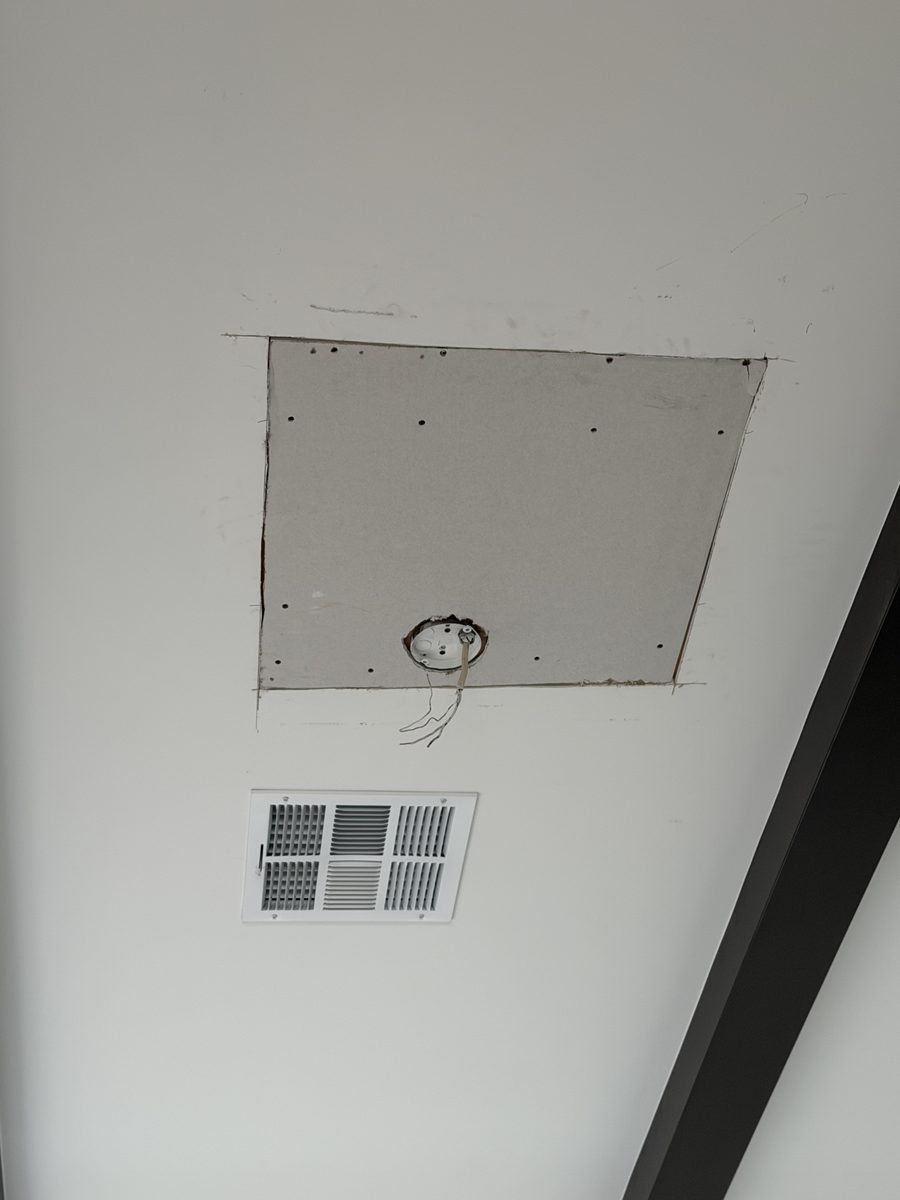 Square drywall plug screwed off to new blocking in a smooth Phoenix ceiling with the fixture wire pulled through the box hole