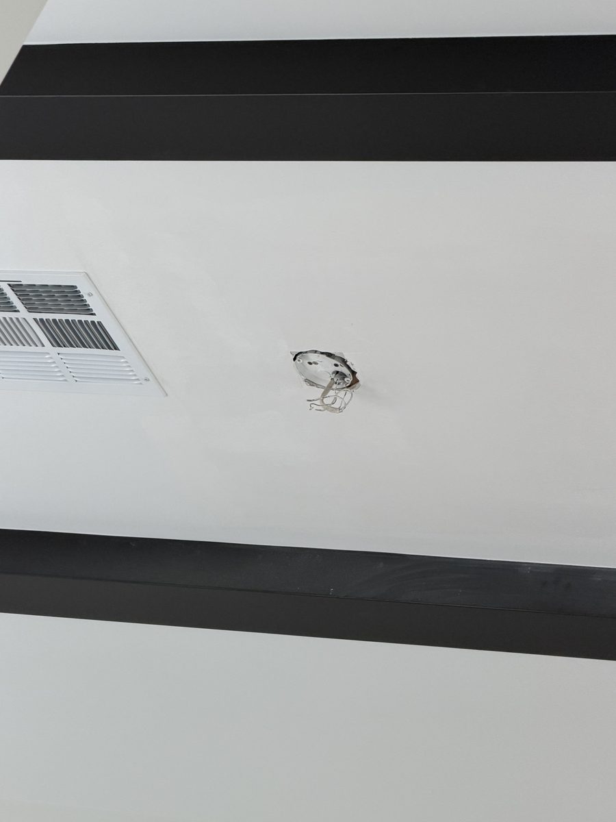 Finished smooth vaulted ceiling with the patch sanded, primed and painted, only the fixture wire showing