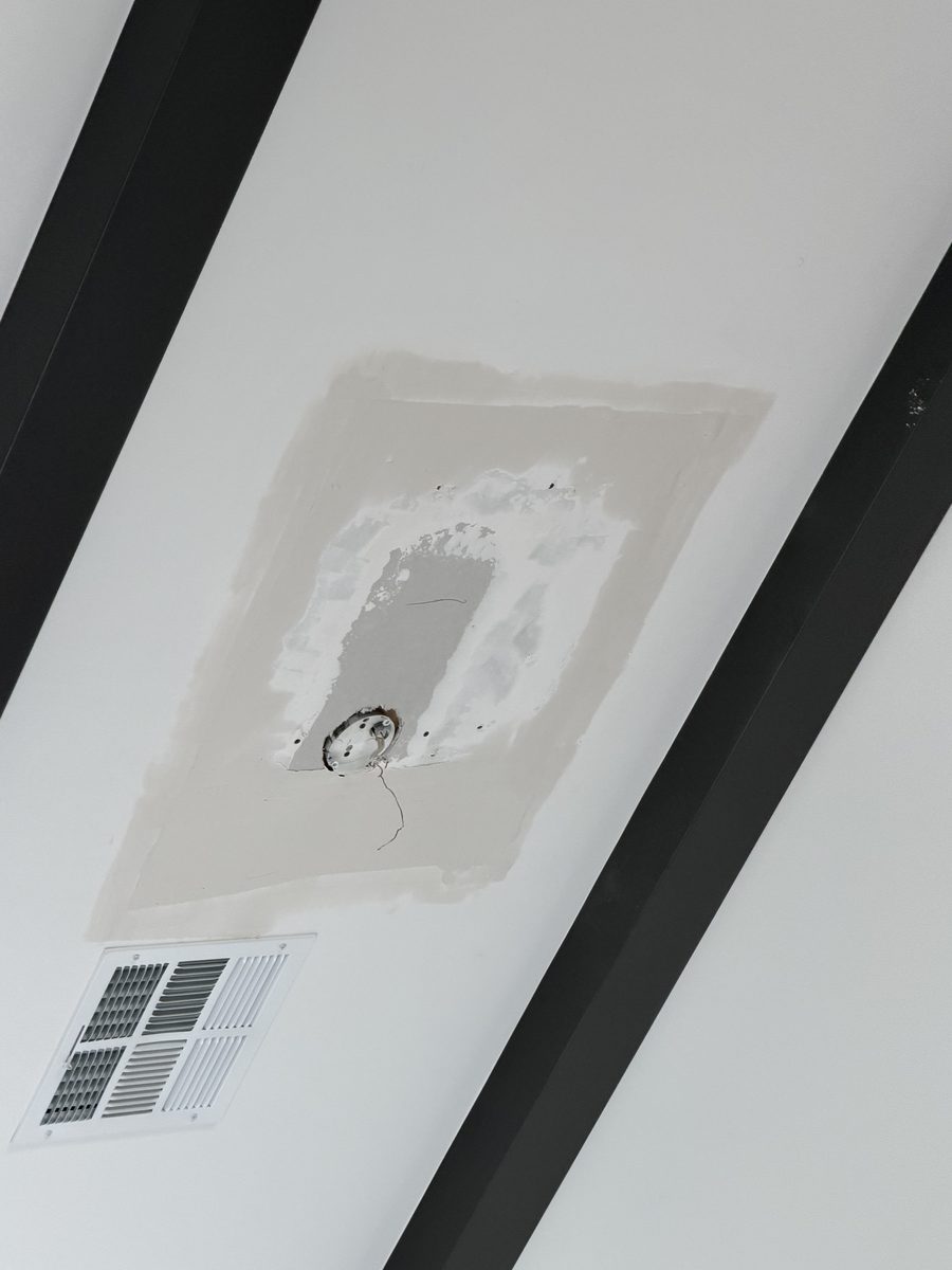 Ceiling patch taped and coated with joint compound, feathered wide into the surrounding smooth vaulted ceiling