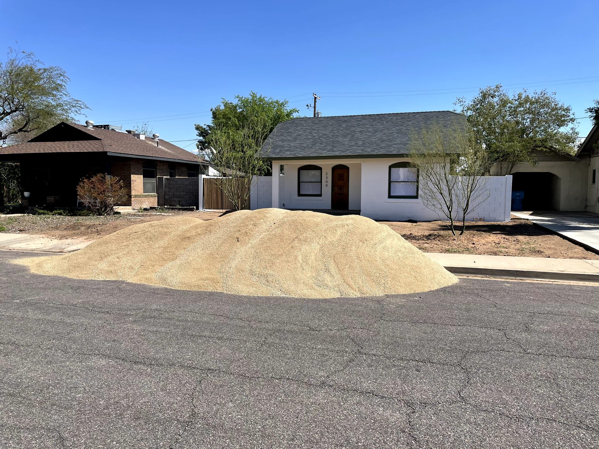 Decomposed granite delivered and ready to grade across a front yard, Coronado district Phoenix
