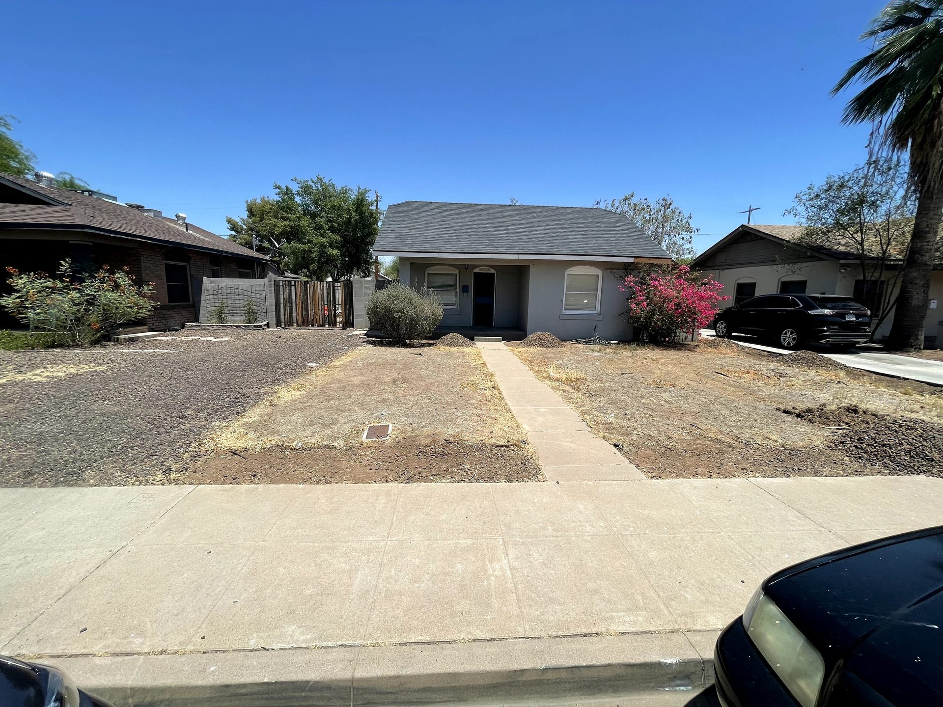 Bare dirt front yard before desert landscaping at a Coronado Historic District bungalow in Phoenix