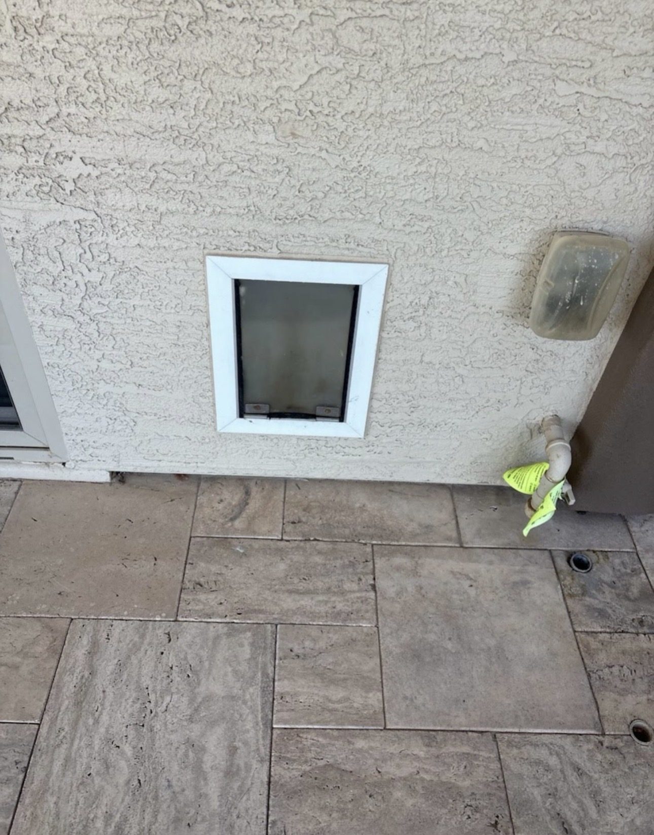 Before: Undersized pet door in exterior stucco wall Phoenix AZ