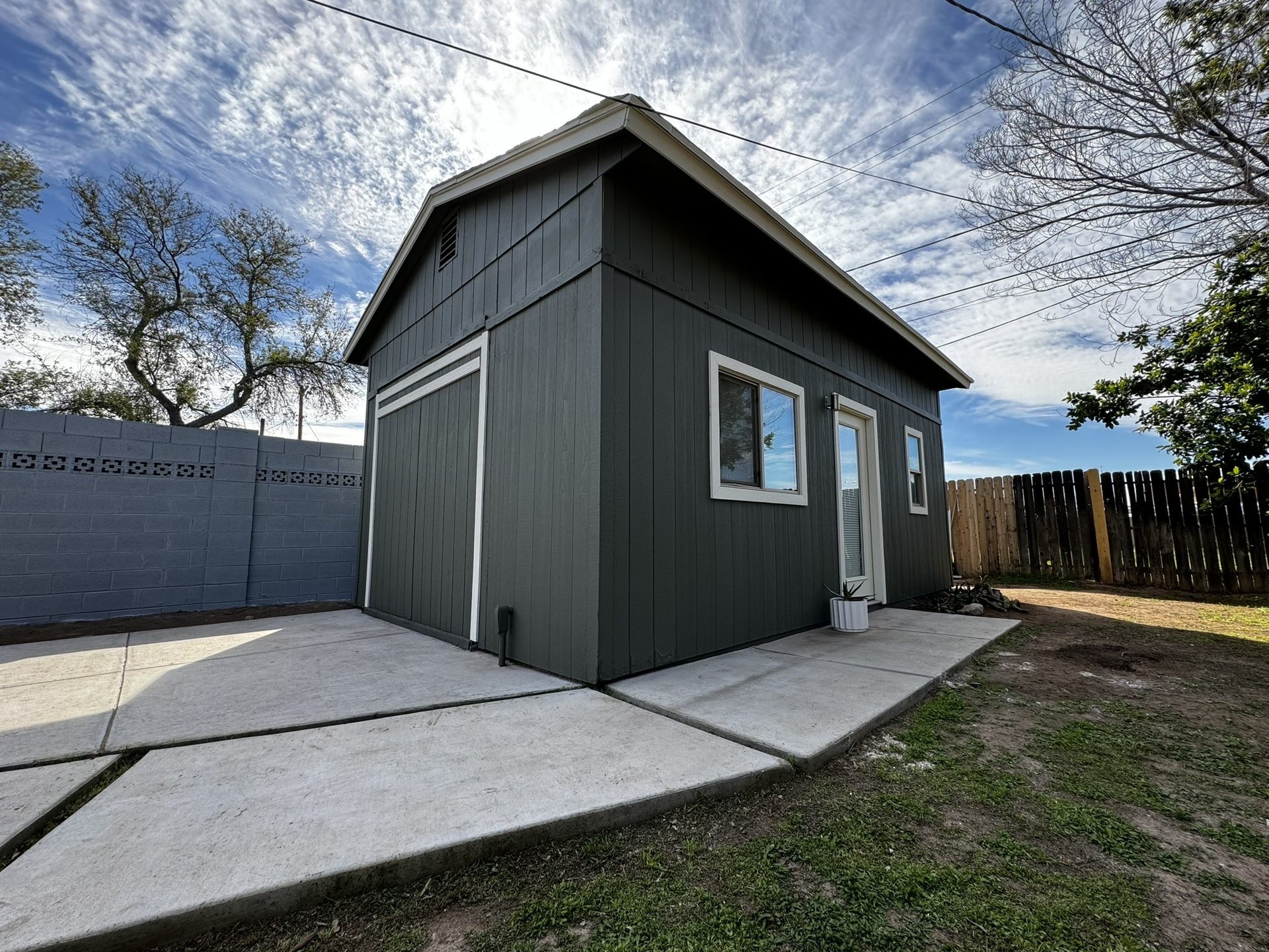 Guest house repainted charcoal green with white trim in Tempe