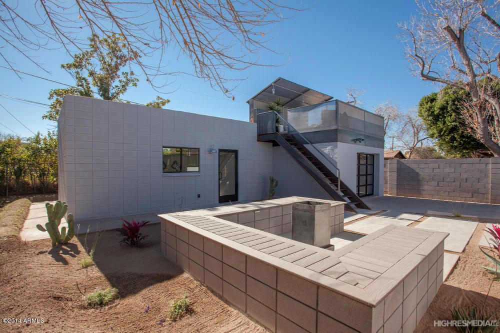 Detached block guest house in the Phoenix metro with an exterior steel stair to a rooftop deck