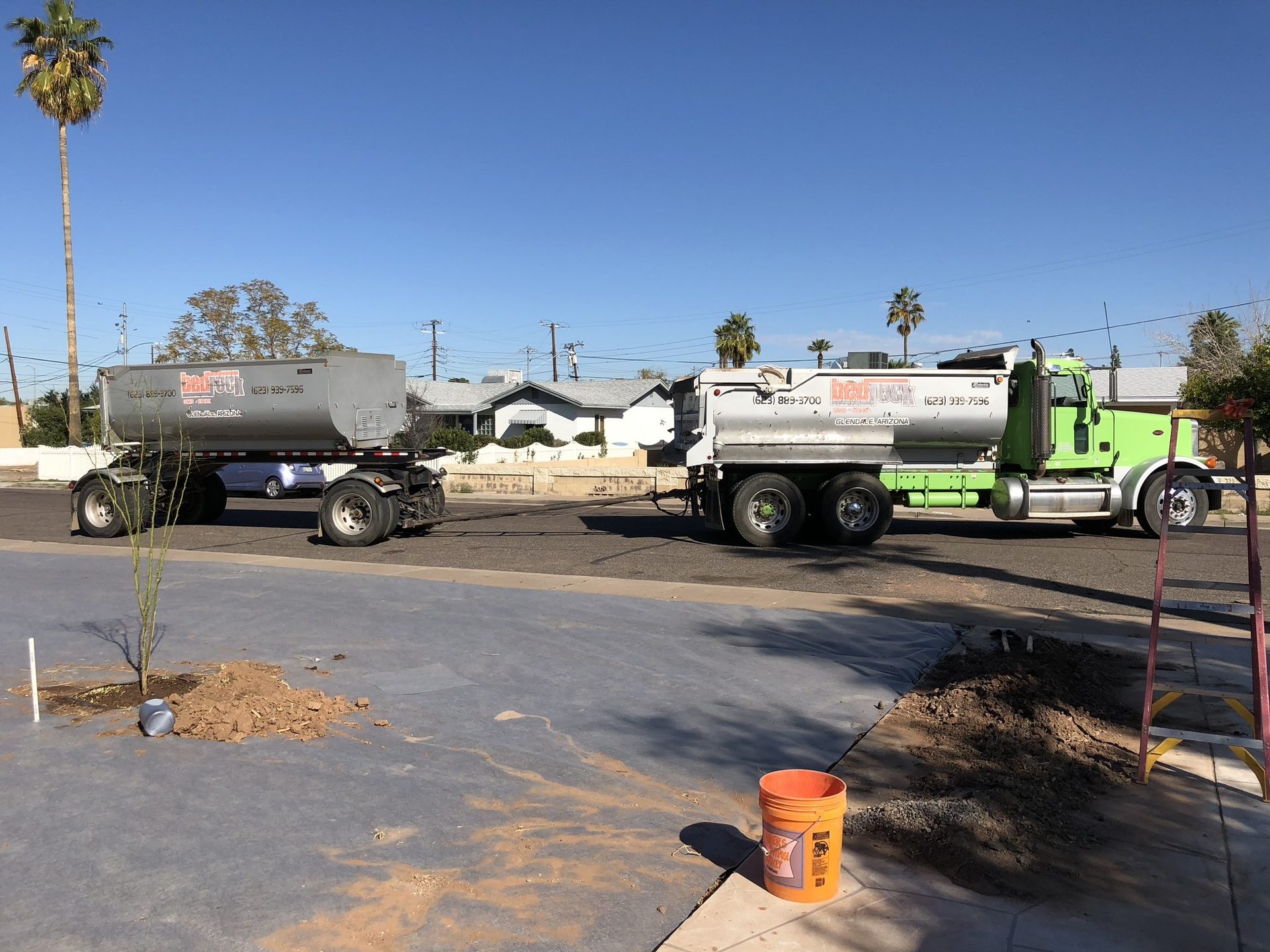 Dump truck haul-off and decomposed granite delivery for a Phoenix desert landscape