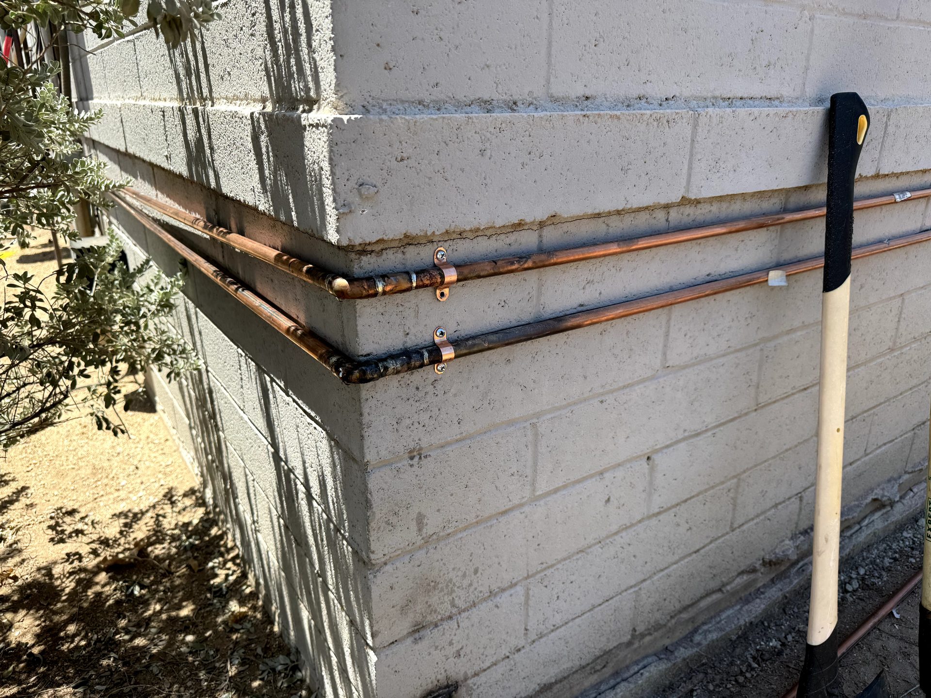 New copper hot and cold supply lines run to a laundry alcove by a licensed plumber in Phoenix