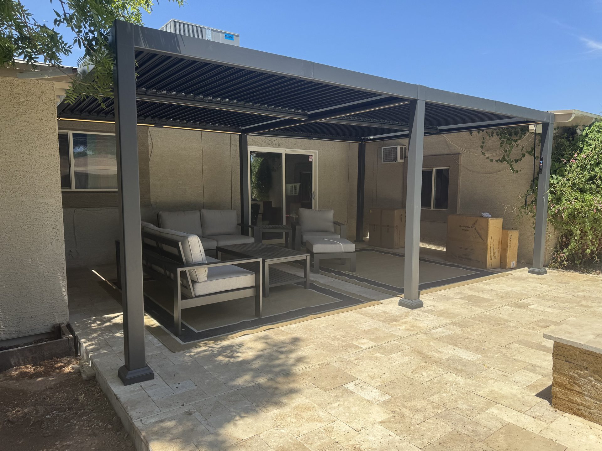 Aluminum louvered pergola over a paver patio in a Phoenix backyard