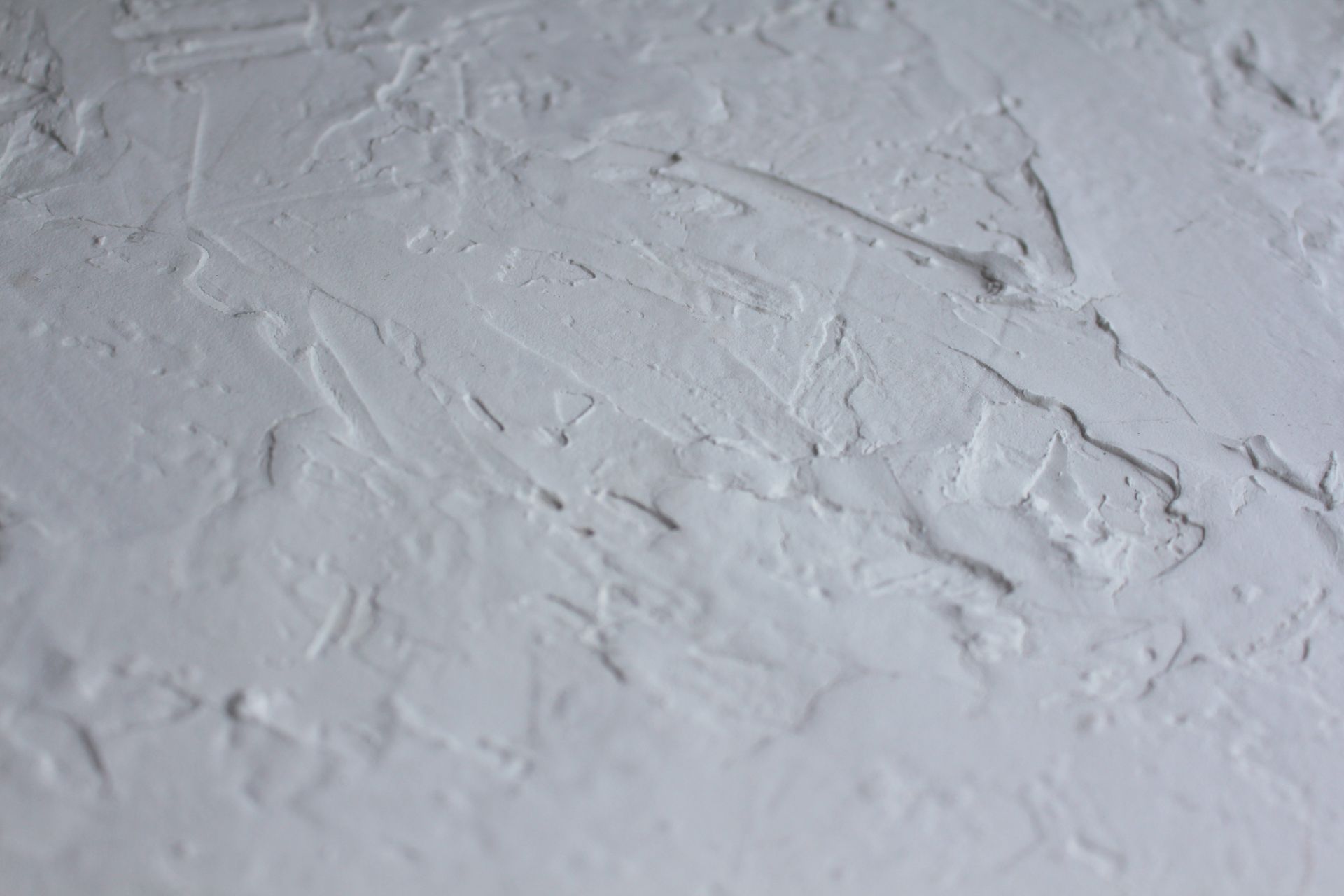 Close-up of a hand troweled mineral plaster wall showing trowel movement and depth