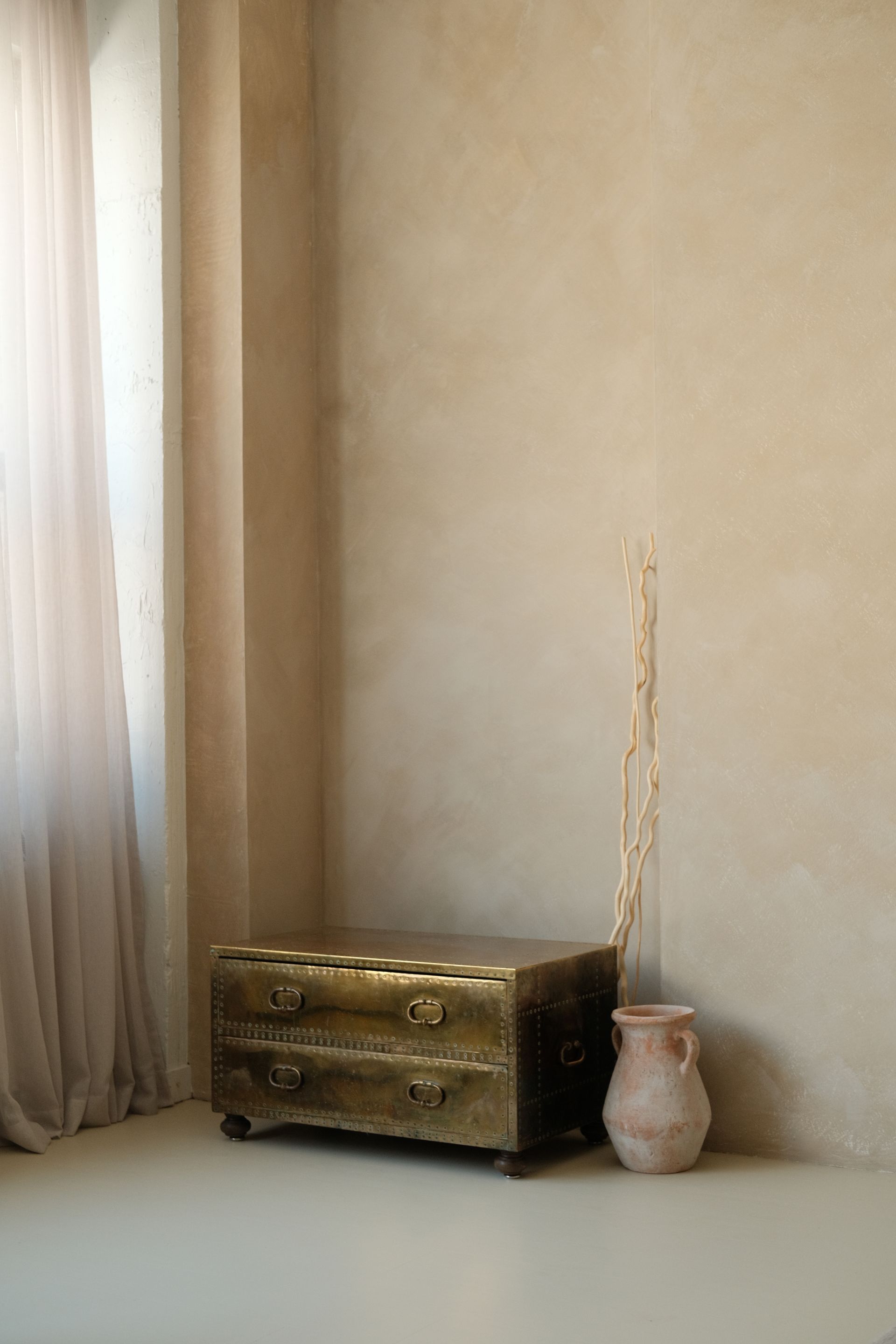 Troweled lime plaster wall in a warm cream tone with soft depth and sheen