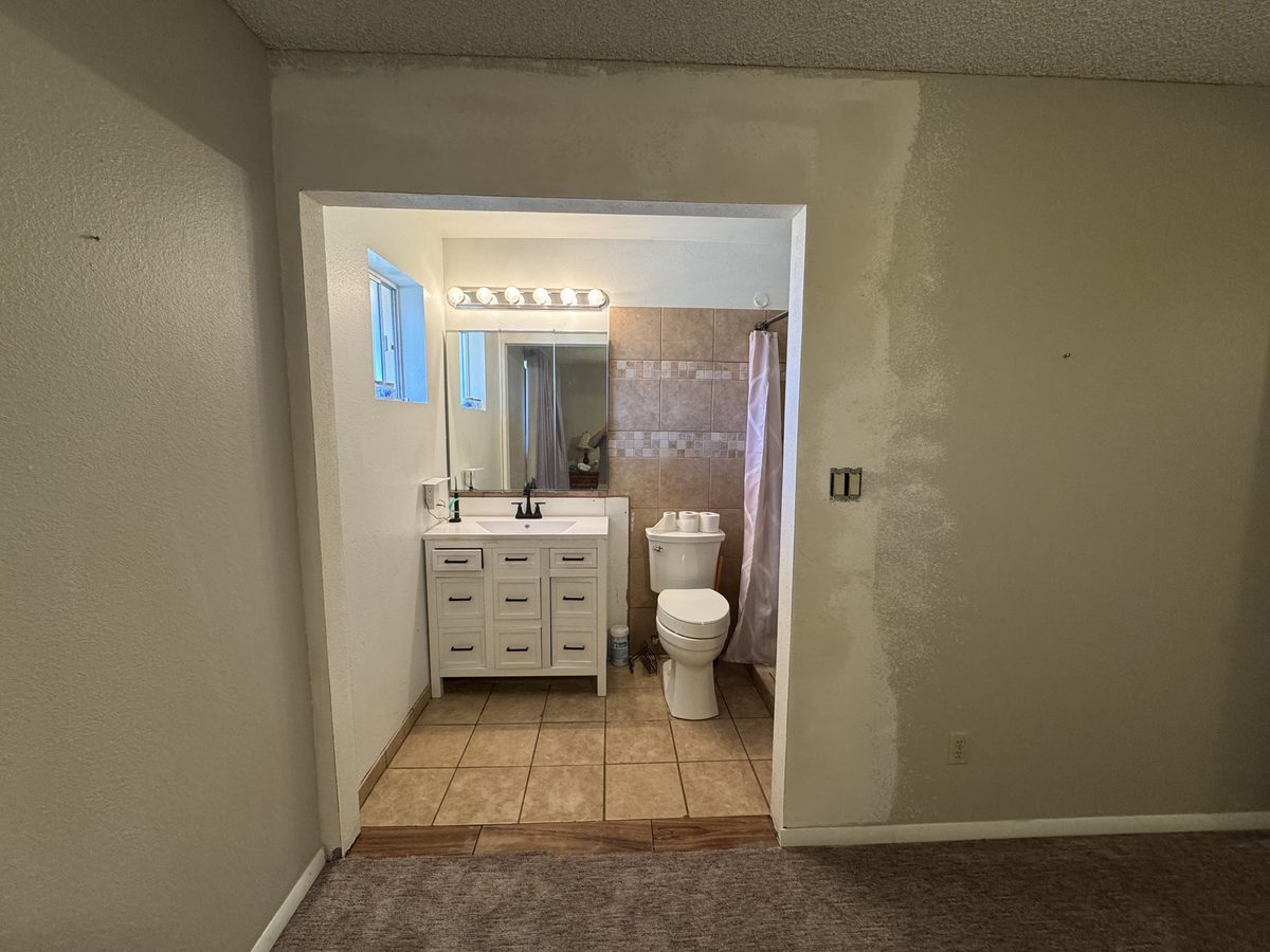 Widened bathroom opening during construction, reframed and patched before stucco and paint