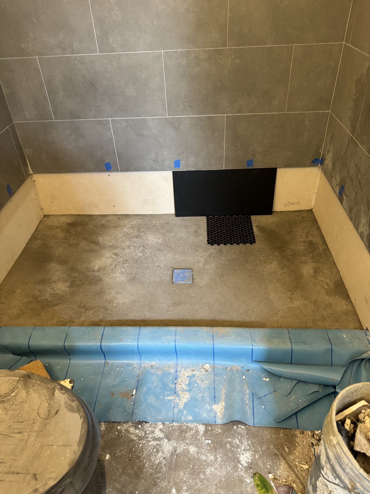 Shower pan bed and drain prepared before tile in a Phoenix bathroom