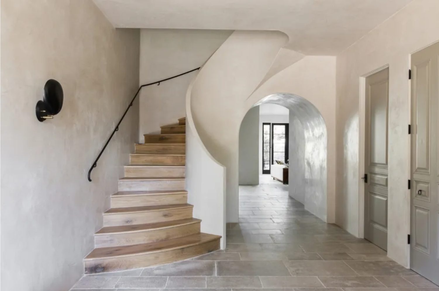 Burnished Venetian plaster on a curved stair wall and arched hallway in a Phoenix-area home