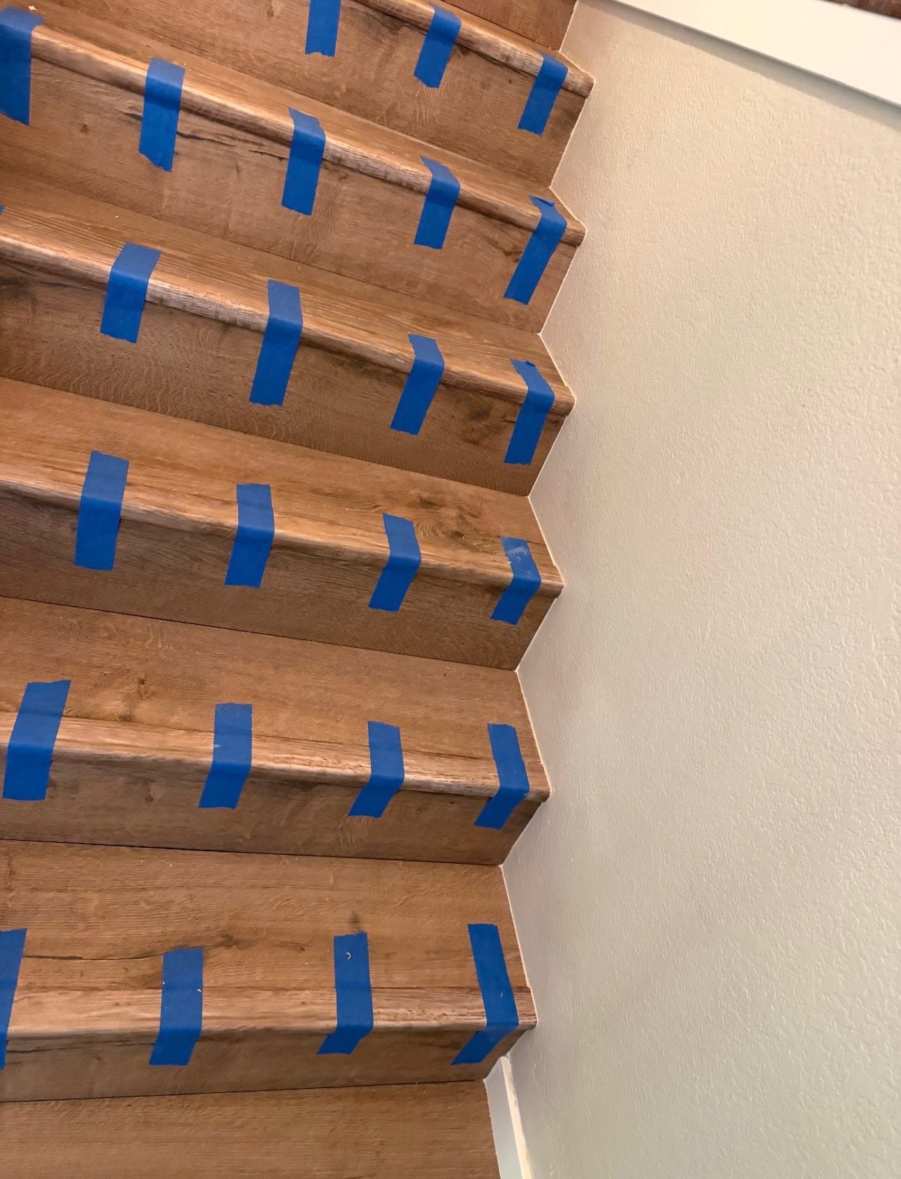During: vinyl plank stair treads taped while adhesive sets Phoenix AZ
